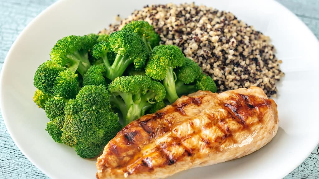 lean chicken with quinoa on the side, steamed vegetables